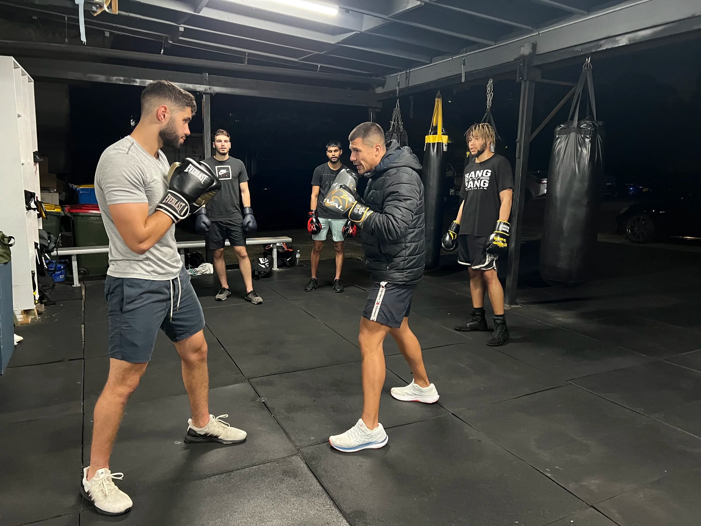 A Legends Gym coach holding pads during a one-to-one boxing session